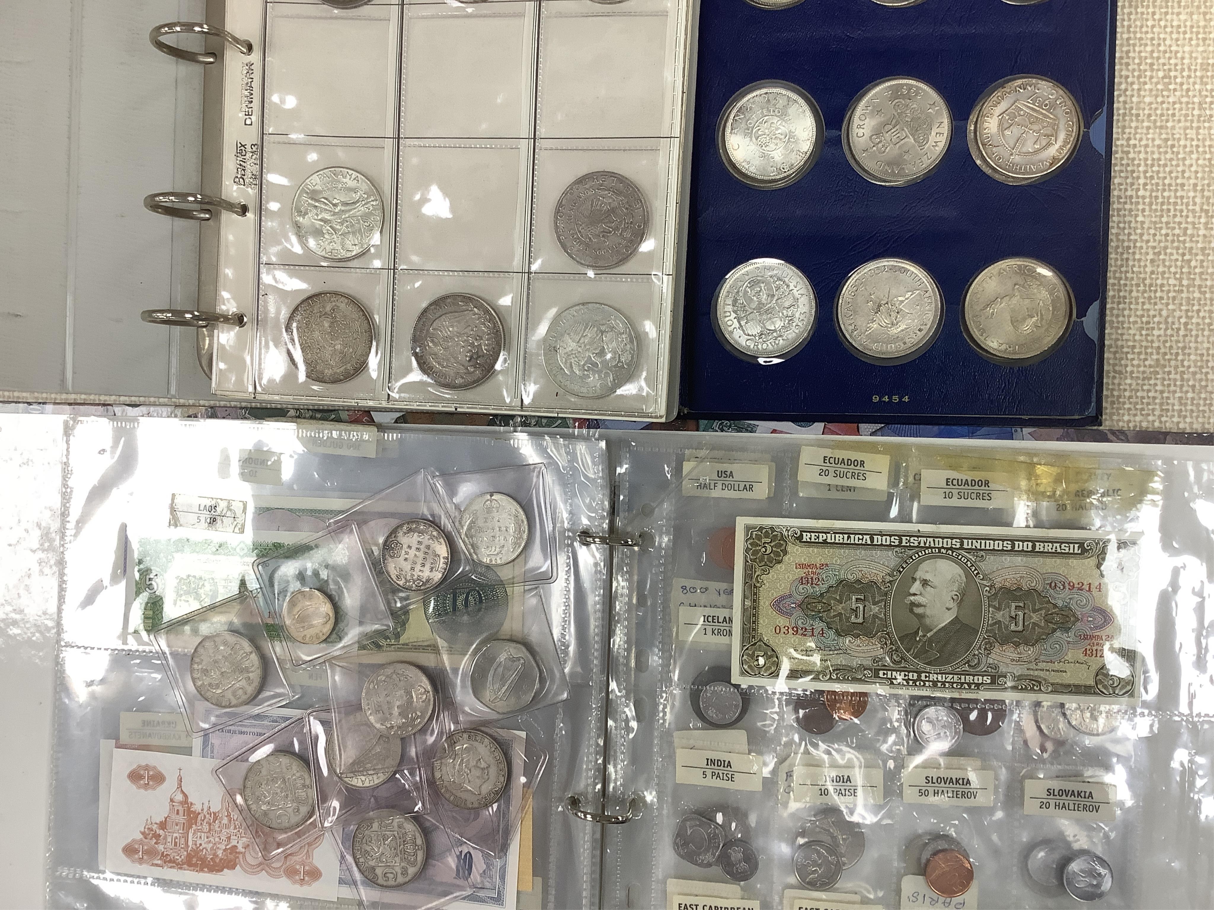 World coins and banknotes, including ‘crowns of the world’ Bermuda, Canada South Africa etc some may be replicas, in three albums, together with examples in clear plastic wallets the majority 1950 or later